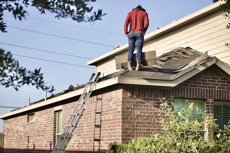 Professional roofer working on a residential roof in Onward